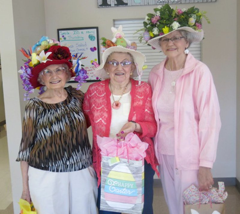 Westside Eagle Observer/SUSAN HOLLAND Pictured posing with their gift bags are Betty Howard, Connie Adams and Jeanie Easley, winners in the annual Easter bonnet contest at the Billy V. Hall Senior Activity Center. With 15 entries in the contest, it was difficult to choose a winner. These three ladies received the most applause and were chosen as the top three.