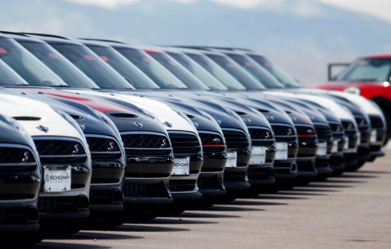 In this Friday, March 30, 2018, photograph, a line of unsold 2018 Cooper Clubmen sit in a long row at a Mini dealership in Highlands Ranch, Colo. U.S. auto sales grew 6.3 percent in March on rising sales of SUVs and pickup trucks. (AP Photo/David Zalubowski)
