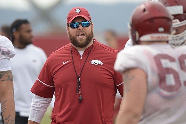 Arkansas offensive line coach Dustin Fry directs his players Saturday, March 10, 2018, during practice at the university practice field in Fayetteville. 