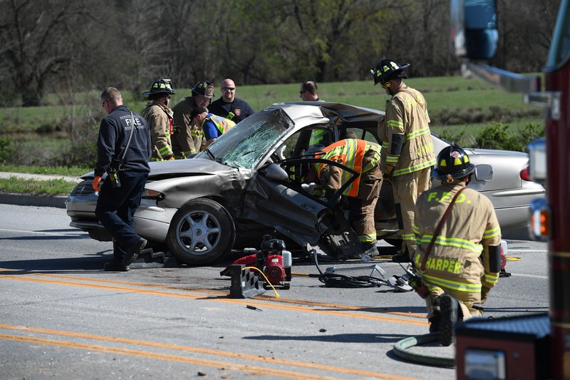 NWA Democrat-Gazette/J.T. WAMPLER Fayetteville firefighters and police work Wednesday April 4, 2018 at the scene of a fatal accident on Huntsville Rd. near Jarnagan Ln. The collision occurred between a Dodge truck and a four-door passenger car. The male driver of the car was killed and the driver of the truck and a passenger from the car, both males, were also transported to the hospital according to Fayetteville fire department personnel.