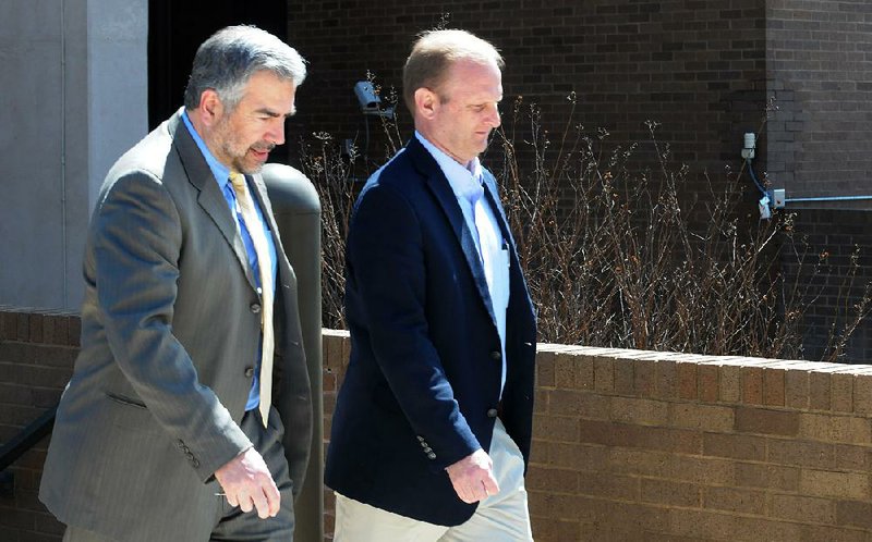 Oren Paris III (right) and attorney Greg Payne of the Story Law Firm leave federal court Wednesday in Fayetteville after Paris pleaded guilty to fraud and agreed to testify against his co-defendants. 