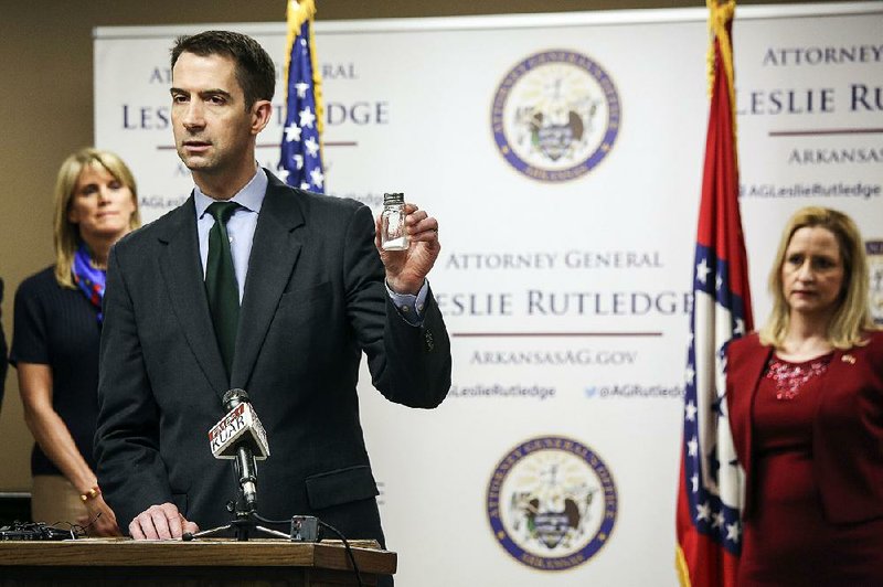 U.S. Sen. Tom Cotton, R-Ark., uses a salt shaker to illustrate that a similar quantity of the drug fentanyl would kill thousands of people. Cotton and Arkansas Attorney General Leslie Rutledge held a news conference Wednesday to discuss their efforts to fight opioid problems.  