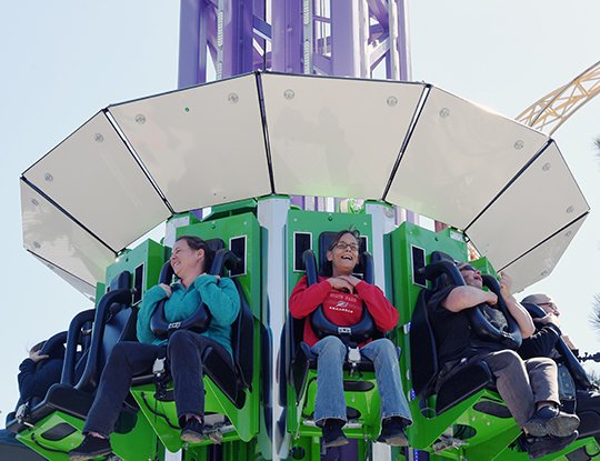 The Sentinel-Record/Grace Brown THRILLING: Karla McCaslin, center, holds on tight after riding Brain Drain, Magic Springs Theme & Water Park's new 13-story thrill ride, on Wednesday as part of the park's media preview day.