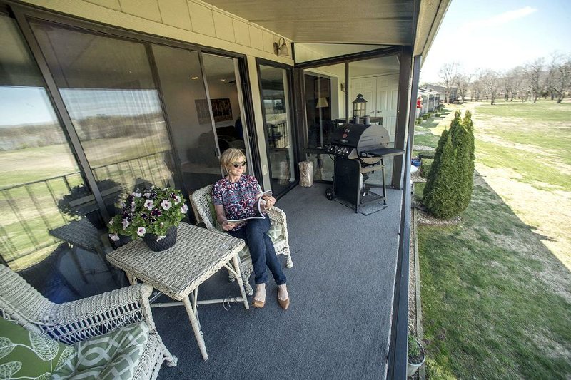 Alison Levin sits on the porch of her Beaver Lake condo, Saturday March 24, 2018. 