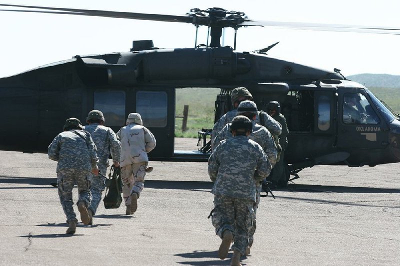 Members of the Arkansas National Guard’s 39th Infantry Brigade who were deployed to New Mexico by President George W. Bush board an Oklahoma National Guard helicopter to be airlifted to an observation site near the Mexican border in August 2006. Gov. Asa Hutchinson said Thursday that he has offered the support of the Arkansas National Guard for President Donald Trump’s plan to bolster border security.  