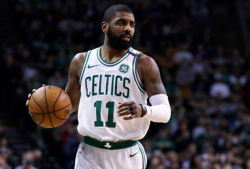 FILE - In this Feb. 28, 2018, file photo, Boston Celtics guard Kyrie Irving (11) moves down court during the first quarter of an NBA basketball game in Boston. A person with knowledge of the situation says Celtics point guard Kyrie Irving will miss the rest of the regular season and playoffs after surgery on his left knee. The official spoke on the condition of anonymity to The Associated Press because the team has not released the news. (AP Photo/Charles Krupa)