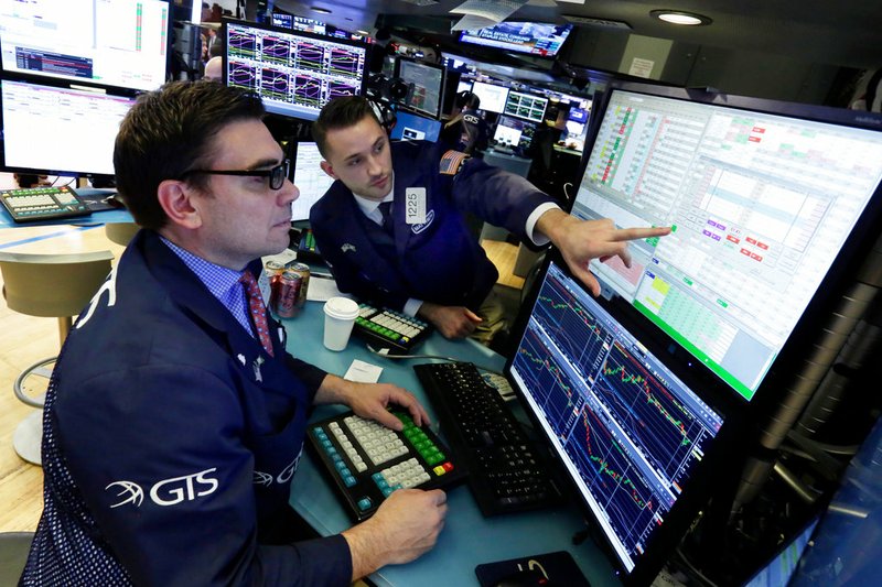 Specialists Robert Tuccillo, left, and Matthew Greiner work at their post on the floor of the New York Stock Exchange on Friday, April 6, 2018.