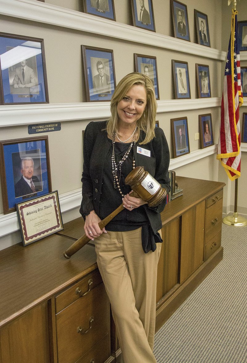 New Jacksonville Chamber of Commerce Chairwoman Sheryl Boyd stands in the board room of the chamber office in Jacksonville. Boyd, who graduated from Jacksonville High School in 1981, said she knows so many of the former chairmen who are pictured in the board room because she helped sell them shoes at the shoe store that her father owned.