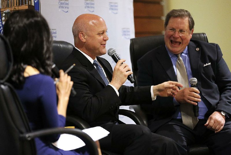 New Orleans Mayor Mitch Landrieu (center) shares a light moment with Little Rock Mayor Mark Stodola before the start of a discussion at the Little Rock Community Safety Summit on Friday in Little Rock. The pair discussed ways to address violence in cities.