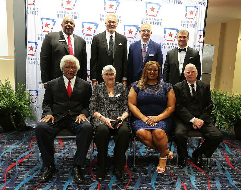 Arkansas Sports Hall of Fame Members of the 2018 induction class of the Arkansas Sports of Hall of Fame get together prior to the induction ceremony Friday night at the Statehouse Convention Center in Little Rock. They are (bottom row, from left) Oliver Elders, Bettye Wallace, Jerval Watson (daughter of inductee Jerry Eckwood) and Dean Weber; (top row, from left) Brison Manor, John Hutchcraft, Jerry Muckensturm and Kevin Scanlon. Eckwood and Shawn Andrews were unable to attend. 
