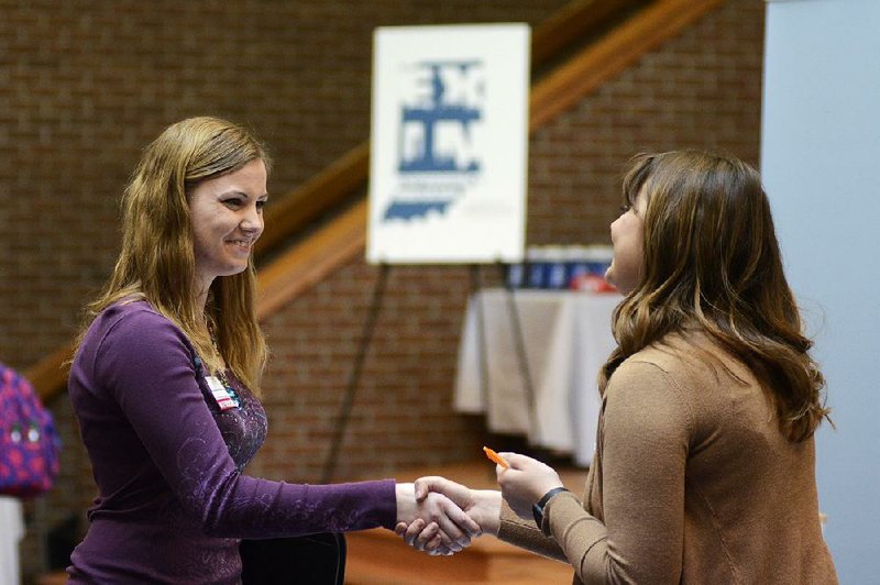 College senior Courtney Kingma (left) thanks Jennie Hehe of Tangram for talking with her during a job fair in March at Indiana Wesleyan University in Marion, Ind.