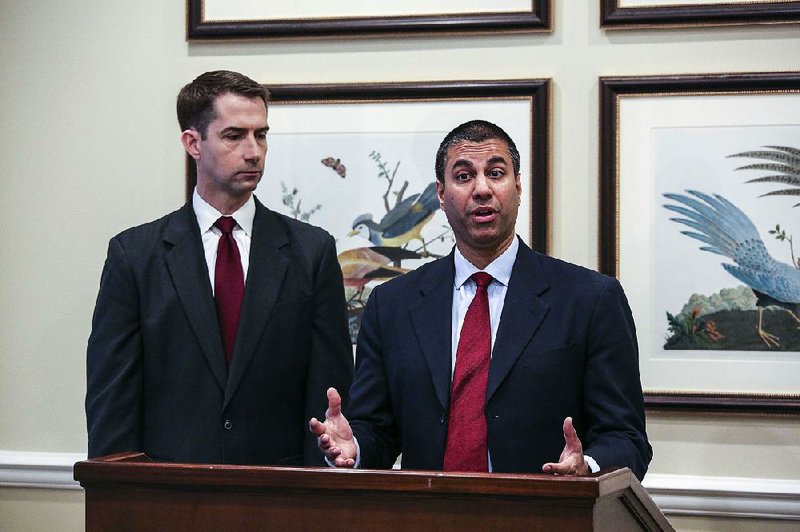 U.S. Sen. Tom Cotton (left) attends a news conference with FCC Chairman Ajit Pai on April 6, 2018, in Little Rock.