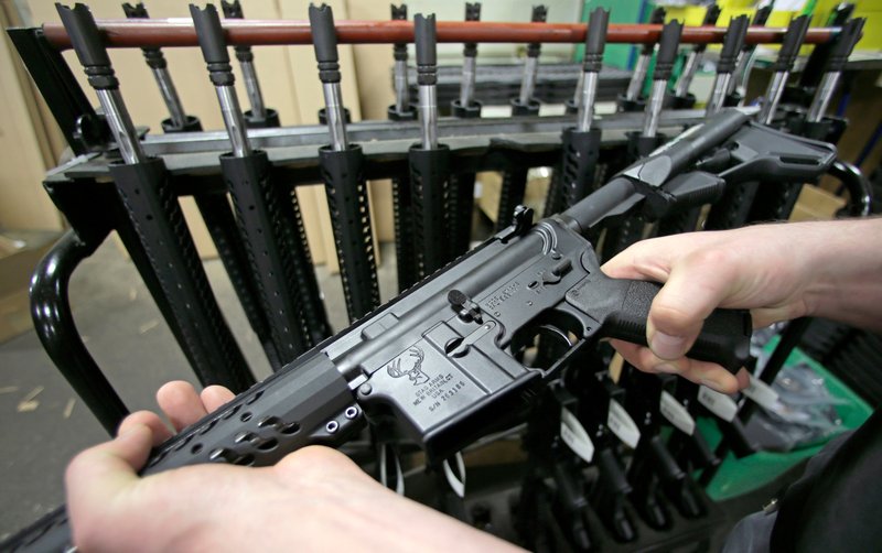 In this April 10, 2013 file photo, craftsman Veetek Witkowski holds a newly assembled AR-15 rifle at the Stag Arms company in New Britain, Conn. A ruling released Friday, April 6, 2018, by a federal judge in Boston, dismissed a lawsuit challenging Massachusetts' ban on assault weapons and large-capacity magazines, stating that assault weapons are beyond the scope of the Second Amendment right to "bear arms." (AP Photo/Charles Krupa, File)
