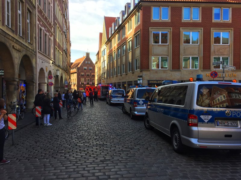 Police vans stand in downtown Muenster, Germany, Saturday, April 7, 2018. German news agency dpa says several people were killed after a car crashes into the crowd in city of Muenster. (dpa via AP)