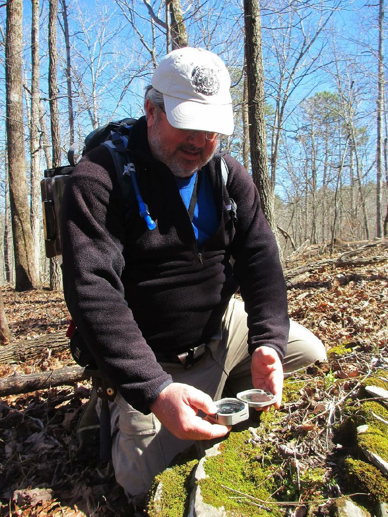 Geologist Richard Hutto measures the location and angle of a rock in the Blanchard Springs recreational area while looking for a fault line last month.  