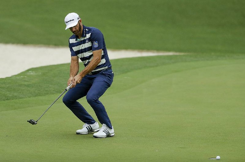 Dustin Johnson reacts after missing a birdie putt on the 10th hole Saturday at the Masters. Johnson and Jordan Spieth both shot 1-under par 71s in the third round, but are considered long shots to win the year’s first major.  
