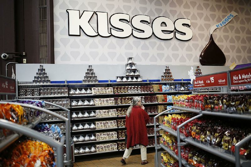 A shopper browses packages of Hershey Kisses at the company’s Chocolate World visitor center in Hershey, Pa.  