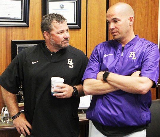 Hot Springs head football coach Chris Vareen, left, and Fountain Lake head football coach JD Plumlee talk at the Greater Hot Springs Chamber of Commerce Tuesday, April 3, 2018, prior to a ceremony announcing the First Security Bank Kickoff Classic Between Hot Springs and Fountain Lake. (The Sentinel-Record/Richard Rasmussen)