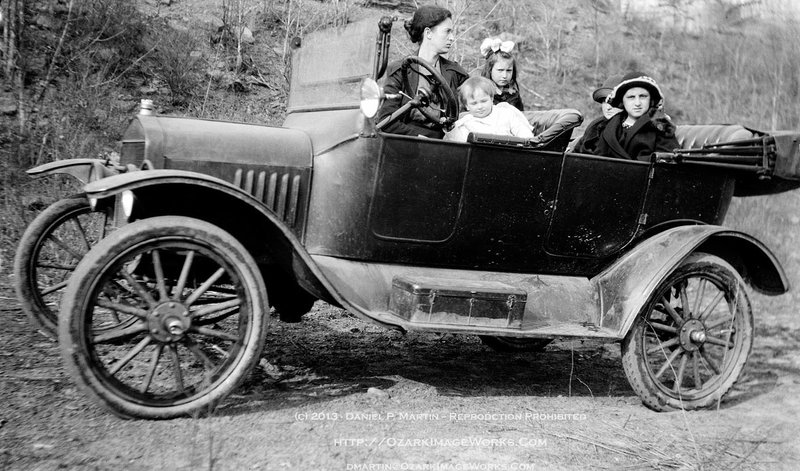 Helen Mooney Barker, longtime proprietor of the Mooney-Barker Drug Store in Pettigrew, is pictured as a young mother with a car full of kids in an image scanned from the original negative inscribed “1 mile west of Pettigrew.” The sale of the drug store forged a relationship between the Pettigrew community and the Shiloh Museum, which in turn created the annual Pettigrew Day event.