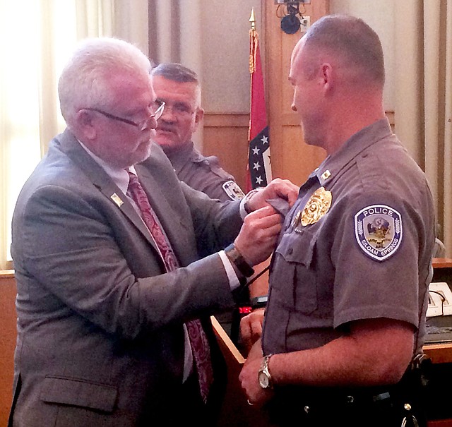 Janelle Jessen/Herald-Leader City administrator Phillip Patterson pinned an FBI Academy professional development ribbon on Captain Todd Brakeville's uniform during the city board meeting on Tuesday as Police Chief Jim Wilmeth looked on. Brakeville recently graduated from the FBI Academy program in Quantico, Va.