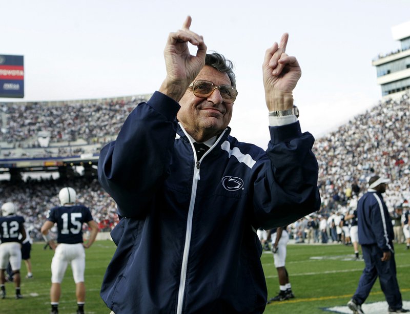 FILE - In this Nov. 5, 2005, file photo, Penn State football coach Joe Paterno acknowledges the crowd during warm-ups before an NCAA college football game against Wisconsin in State College, Pa. "Paterno" aims to tell the polarizing story of a legend's fall, when the most essential question can never be answered. The HBO movie directed by Barry Levinson debuts April 7 and stars Oscar winner Al Pacino as Joe Paterno, the Penn State coach whose career ended in scandal. (AP Photo/Carolyn Kaster, File)