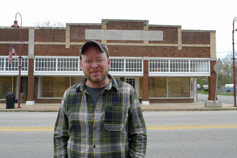 Charlie Bookout, one of the owners of The Carpenter Building in Gentry, stands in front of the building Friday. The building is being nominated for inclusion on the National Register of Historic Places.