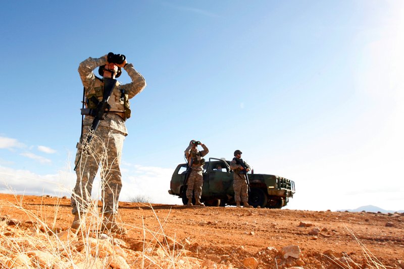 FILE - In this Friday, Jan. 19, 2007 file photo, a National Guard unit patrols the Arizona-Mexico border in Sasabe, Ariz. On Friday, April 6, 2018, Arizona and Texas announced that they were preparing to deploy National Guard members to the U.S.-Mexico border in response to President Donald Trump's call for more border security. From 2006 to 2008, the Guard fixed vehicles, maintained roads, repaired fences and performed ground surveillance. Its second mission in 2010 and 2011 involved more aerial surveillance and intelligence work. (AP Photo/Ross D. Franklin, file)