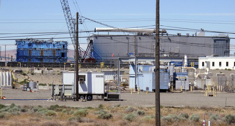 This May 13, 2017, photo shows a portion of the Plutonium Finishing Plant on the Hanford Nuclear Reservation near Richland, Wash. Officials say dozens of workers demolishing the 1940s-era plutonium processing plant there have ingested or inhaled radioactive particles in the past year, prompting a halt to the demolition of the plant until a safe plan can be developed. (AP Photo/Nicholas K. Geranios)