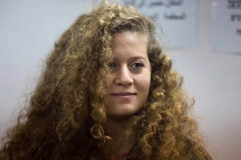 The Associated Press PALESTINIAN IN PRISON: In this Feb. 13 file photo, Palestinian Ahed Tamimi stands inside the Ofer military prison near Jerusalem. The family of Palestinian protest icon Ahed Tamimi released a video during a press conference Monday in which two male Israeli interrogators are seen threatening the then-16-year-old and commenting on her body, fair skin and "eyes of an angel."