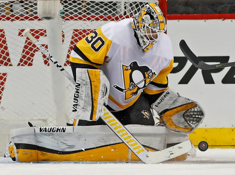 FILE - This March 20, 2018 file photo shows Pittsburgh Penguins goaltender Matt Murray (30) making a save during the third period of an NHL hockey game against the New York Islanders in New York. There are no questions anymore about who the franchise goaltender is for the Penguins. Murray heads into his third Stanley Cup playoffs firmly established as the team's top netminder. Now comes the hard part after a difficult regular season for Murray: backstopping the two-time defending Cup champions to history. (AP Photo/Kathy Willens, file)