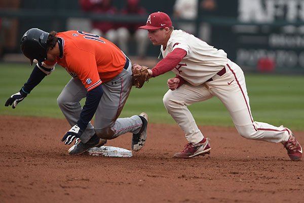 Arkansas shortstop Jax Biggers attempts to tag Auburn's Edouard Julien at second base during a game Sunday, April 8, 2018, in Fayetteville. 