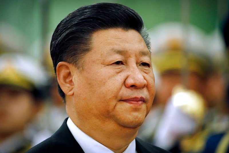 In this March 29, 2018, file photo, Chinese President Xi Jinping reviews an honor guard during a welcome ceremony at the Great Hall of the People in Beijing. Xi has promised to cut China's auto import tariffs and ease restrictions on foreign ownership in its auto industry amid an escalating tariff spat with Washington, in a speech Tuesday, April 10, 2018 at a business conference. (AP Photo/Mark Schiefelbein, File)