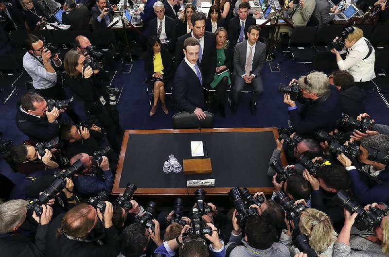 Mark Zuckerberg (center) arrives Tuesday to testify in a rare combined hearing of two Senate committees during which 44 senators questioned the Facebook chief executive.  