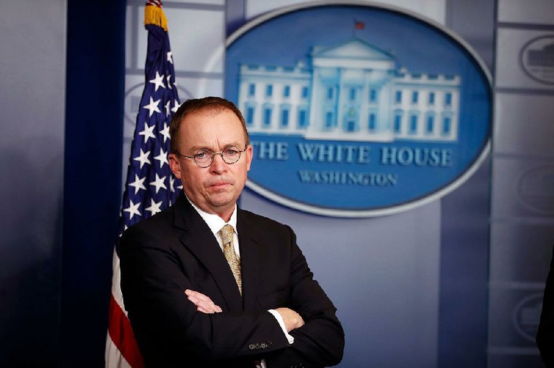In this Jan. 20, 2018, file photo, Director of the Office of Management and Budget Mick Mulvaney stands during a press briefing at the White House in Washington. Mulvaney, appointed acting director of the Consumer Financial Protection Bureau in November, promised to shrink the bureau’s mandate and take a much softer approach to enforcement, and records reviewed by The Associated Press indicate he has kept his word. 