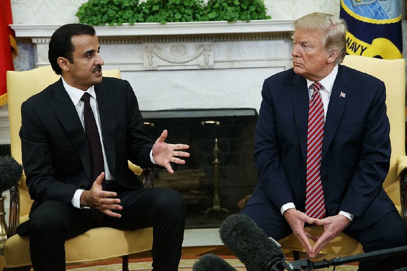 President Donald Trump and Sheikh Tamim bin Hamad Al Thani, the Qatari emir, chat Tuesday in the Oval Office. 