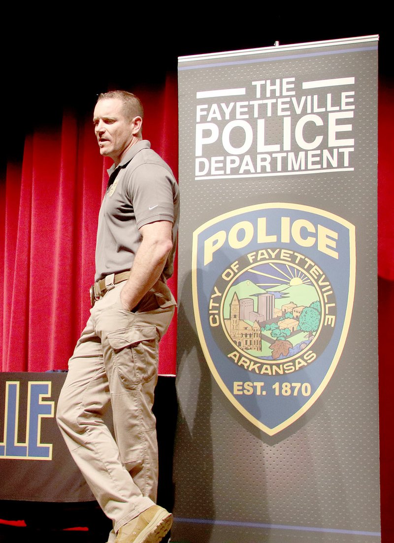 LYNN KUTTER ENTERPRISE-LEADER Sgt. Tony Murphy with the community police division of Fayetteville Police Department, talks to Lincoln Middle School students about a career in law enforcement.