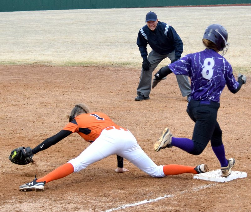 Westside Eagle Observer/MIKE ECKELS Sumer Kaba (Gravette 1) keeps one foot on first base as she stretched out to catch a wild throw during the Lady Lions-Lady Elks softball game in Gravette April 2. Kaba's efforts paid off as the umpire ruled the Elkins runner out.