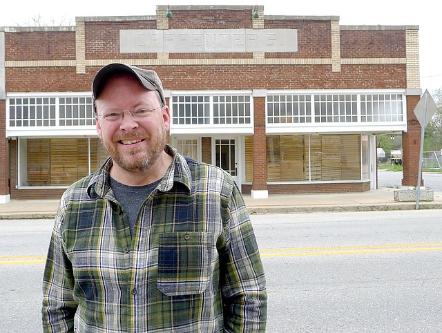 Charlie Bookout, one of the owners of The Carpenter Building in Gentry, stands in front of the building on Friday. The building is being nominated for inclusion on the National Register of Historic Places.