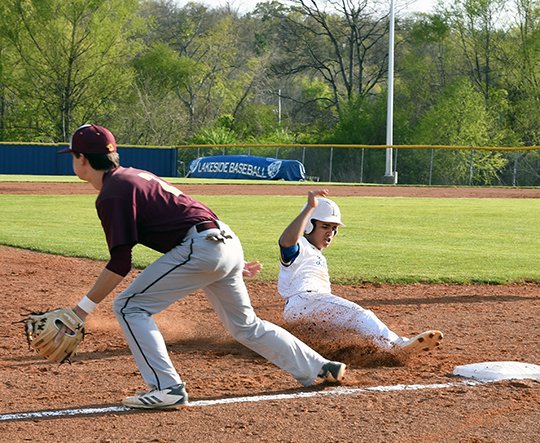 The Sentinel-Record/Grace Brown ELECTRIC SLIDE: Lakeside's Justin Scott (right) slides safely into third base in front of Lake Hamilton's Cole Plyler (2) during a baseball game Monday at Lakeside. Scott finished with one double, one stolen base and two RBIs in Lakeside's 10-0 win.