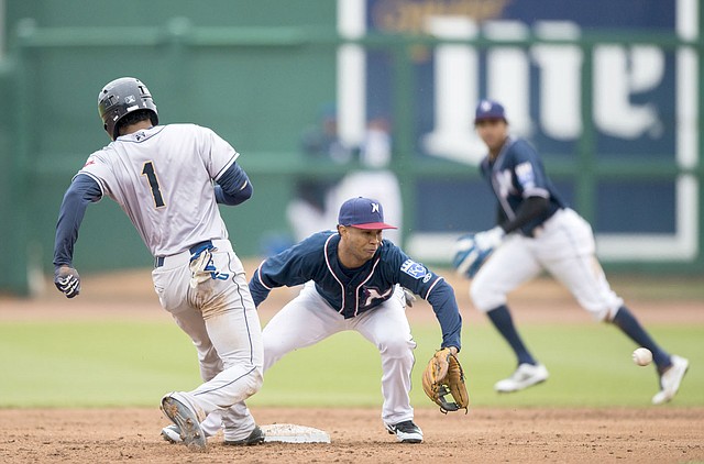 Charlie Kaijo/NWA Democrat-Gazette Northwest Arkansas Naturals shortstop Jecksson Flores (2) tries to tag San Antonio Missions left fielder Rod Boykin (1) during a baseball game on Sunday at Arvest Ballpark in Springdale. The Naturals wrapped up a six-game homestand Tuesday and begin a six-game road trip in Corpus Christi at 7:05 p.m. Thursday. The Naturals return home for two games against Tulsa on April 19-20.