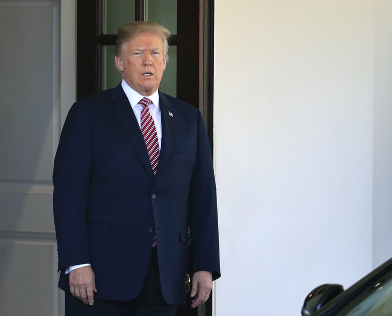 The Associated Press TRUMP WAITS: President Donald Trump waits at the main entrance to the West Wing for the arrival of the Emir of Qatar Sheikh Tamim bin Hamad al-Thani, at the White House in Washington, Tuesday.