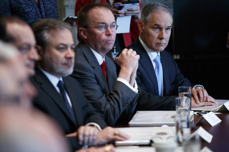 The Associated Press EPA ADMINISTRATOR: Environmental Protection Agency administrator Scott Pruitt, right, listens as President Donald Trump speaks during a cabinet meeting at the White House, Monday in Washington.
