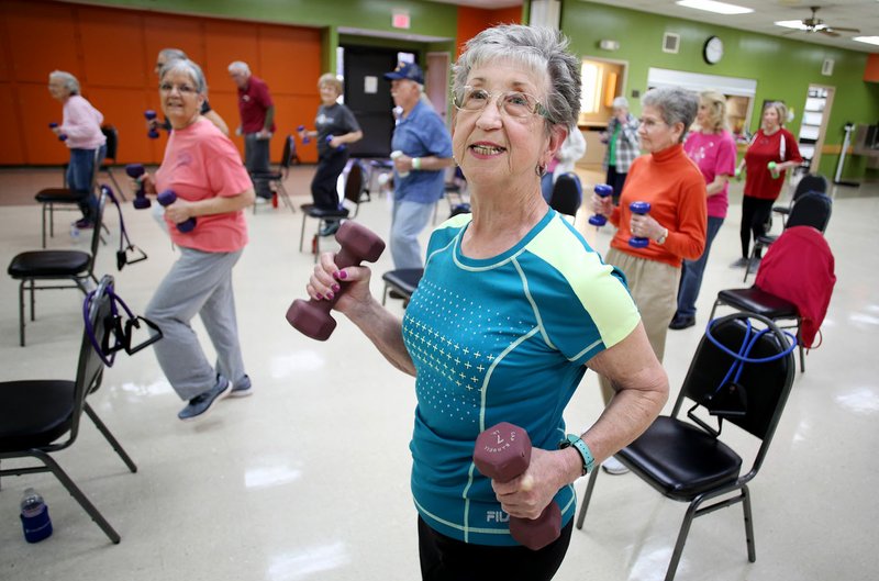 NWA Democrat-Gazette/DAVID GOTTSCHALK Cherie Ressler participates in a Silver Sneakers exercise session Tuesday under the instruction of Cindy Mix at the at the Springdale Senior Activity and Wellness Center. The center will undergo a needs assessment to direct the future of the center.