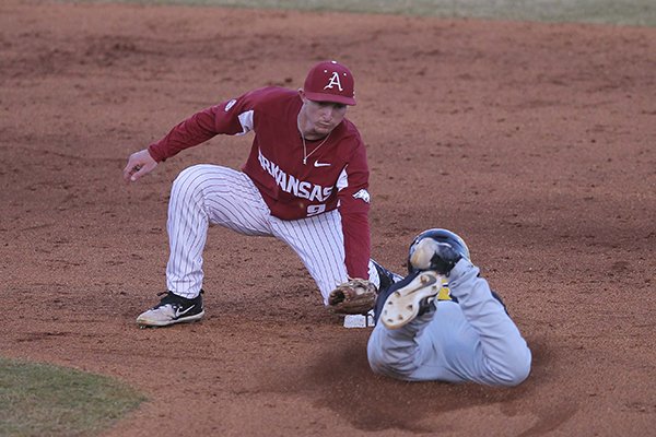 Arkansas shortstop Jax Biggers tags out Grambling State baserunner Kristian Franklin during a game Tuesday, April 10, 2018, at Dickey-Stephens Park in North Little Rock.
