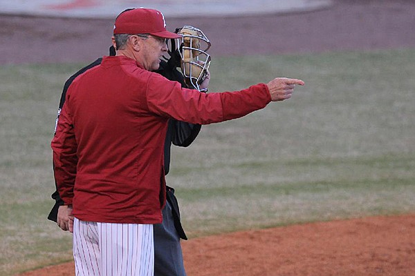Arkansas coach Dave Van Horn speaks with umpire Michael Phillips during a game against Grambling State on Tuesday, April 10, 2018, in North Little Rock. 