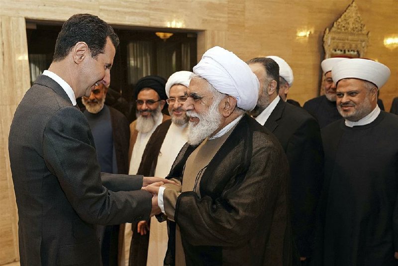 Syrian President Bashar Assad meets a delegation of Muslim clerics from around the world Wednesday in Damascus. A spokesman for Iran’s supreme leader said Wednesday that Tehran would support Assad against foreign aggression. 