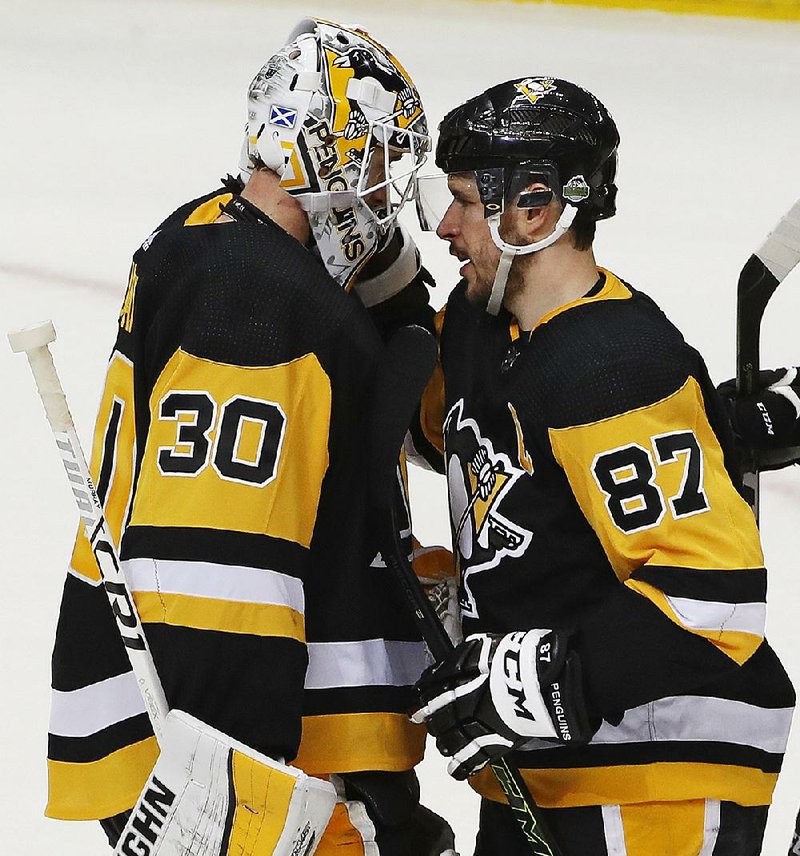 Sidney Crosby (right) congratulates goaltender Matt Murray after the Pittsburgh Penguins defeated the Philadelphia Flyers 7-0 on Wednesday night in Pittsburgh.  