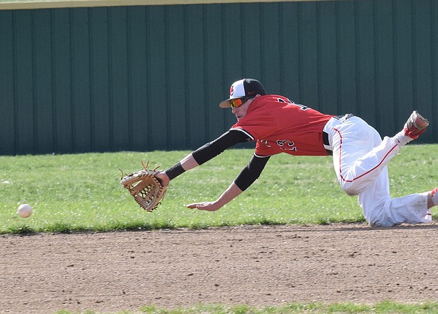 RICK PECK/SPECIAL TO MCDONALD COUNTY PRESS McDonald County shortstop Reece Cooper dives for a ground ball during the Mustangs' 2-1 loss to Webb City on April 4 at Webb City High School.