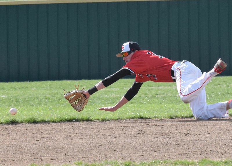 RICK PECK/SPECIAL TO MCDONALD COUNTY PRESS McDonald County shortstop Reece Cooper dives for a ground ball during the Mustangs' 2-1 loss to Webb City on April 4 at Webb City High School.
