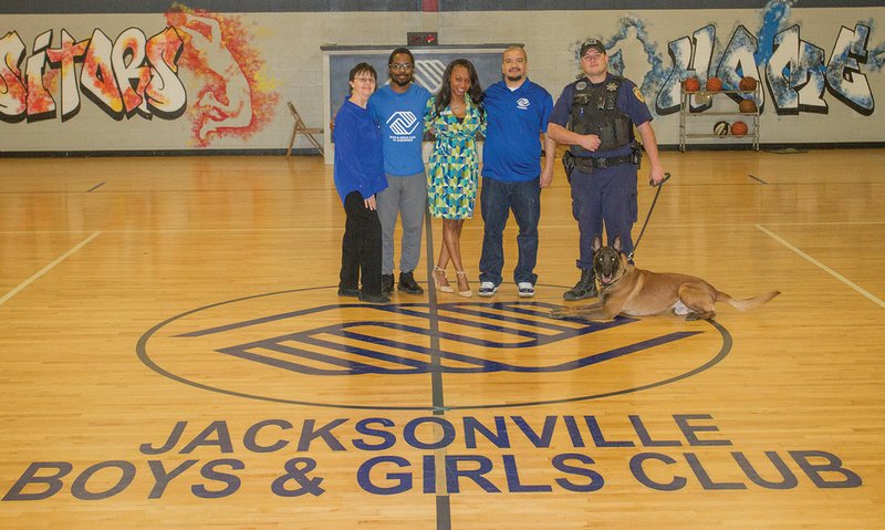 The Jacksonville Boys & Girls Club will have its annual fundraising dinner May 1 at the Jacksonville Community Center. Pictured from the Boys & Girls Club are, from left, Barbie Mellinger, board secretary and volunteer; Chris Woods, volunteer; LaConda Watson, executive director; Mike Williams, programs and athletic director; and Johnny Hicks, board member and guest speaker for the banquet. Hicks is the K-9 officer for the Jacksonville Police Department. With him is Ace, the department’s K-9 dog.